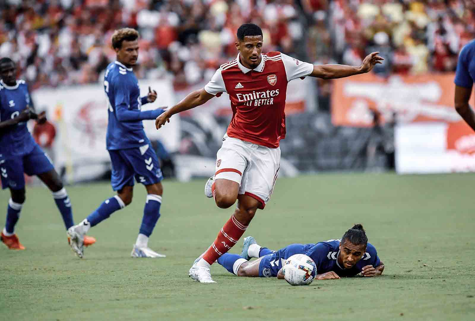 William Saliba playing for Arsenal against Everton in a pre-season friendly, leaving Dominic Calvert-Lewin on the floor